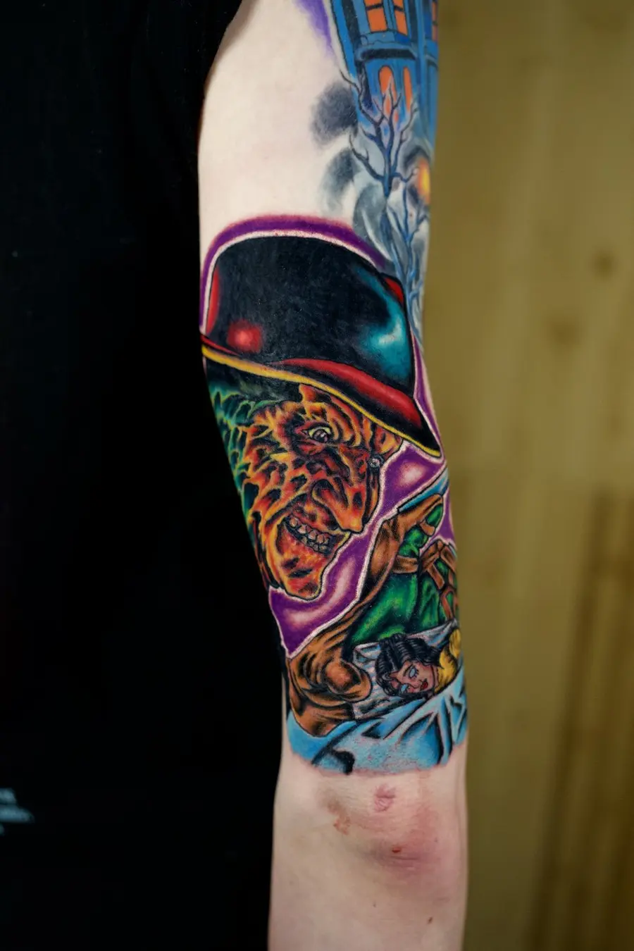 Vivid full-color character sleeve tattoo by Clayton Parnell, West Palm Beach