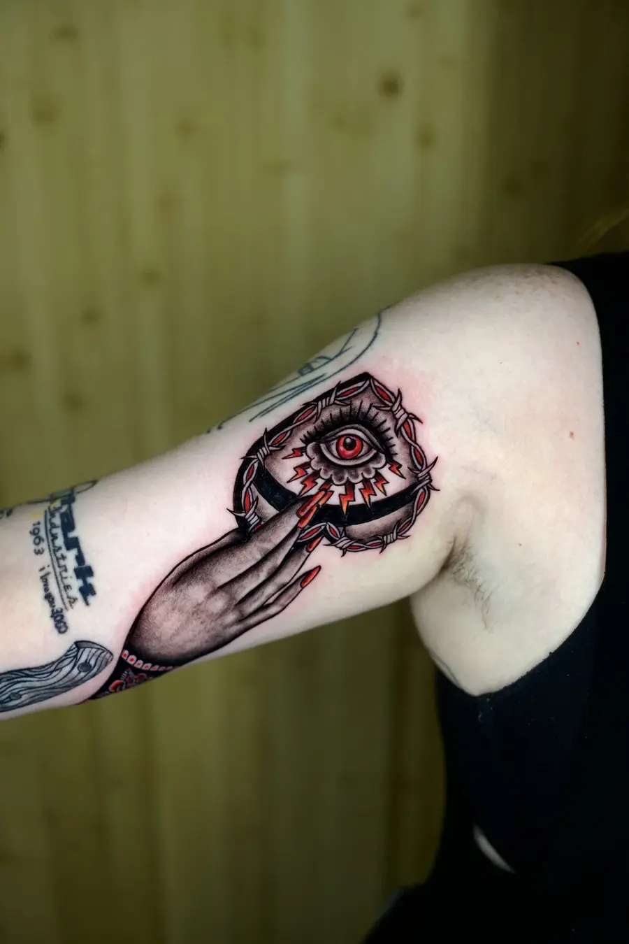 Bold traditional eye and barbed wire tattoo by Clayton Parnell, West Palm Beach